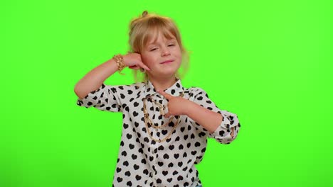 Funny-playful-child-girl-looking-at-camera-doing-phone-gesture-like-says-hey-you-call-me-back