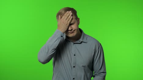 facepalm, fault, omg. upset distressed man on chroma key covering face with head and saying no