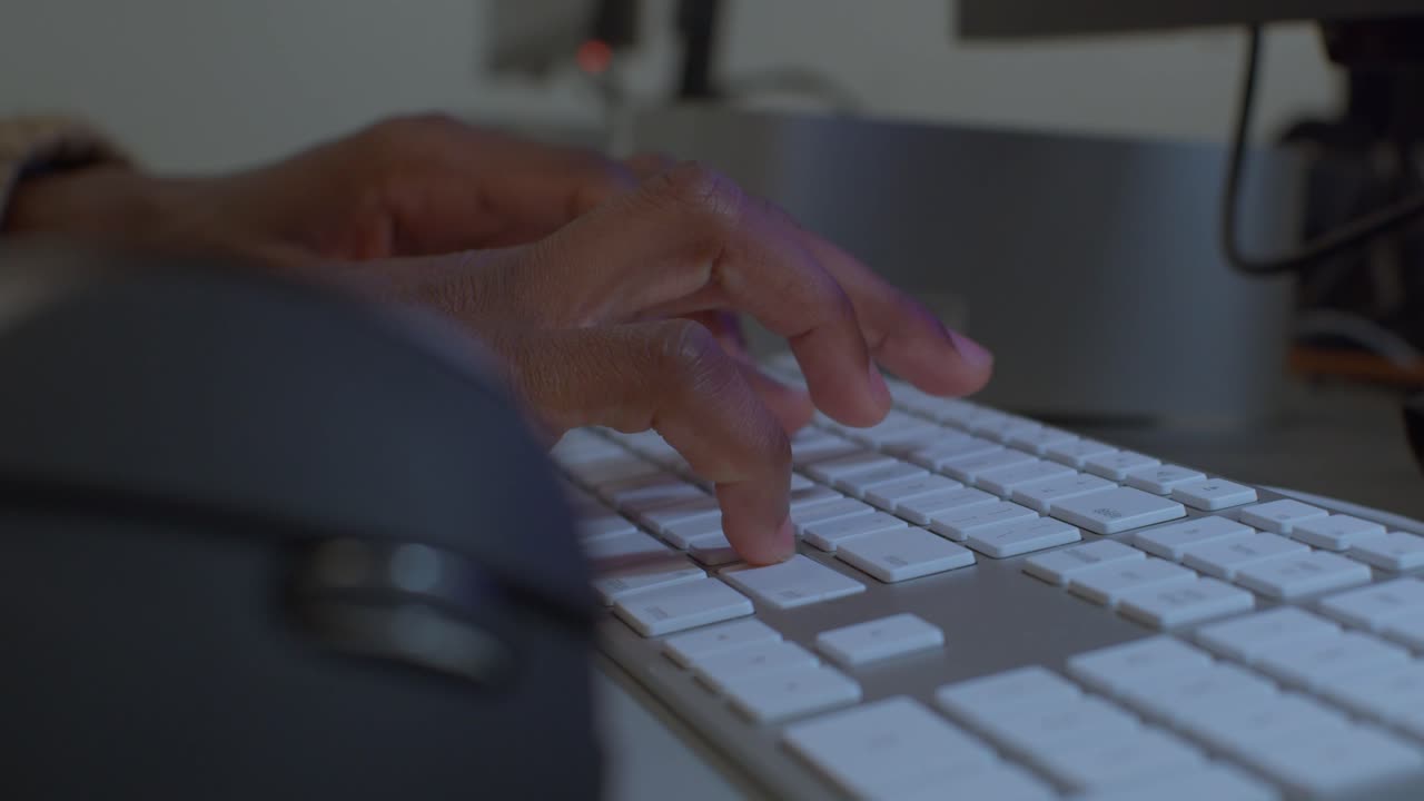 Fingers clicking mouse and typing on keyboard