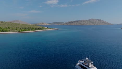 serene aerial view of a yacht in kornati national park, surrounded by clear blue water