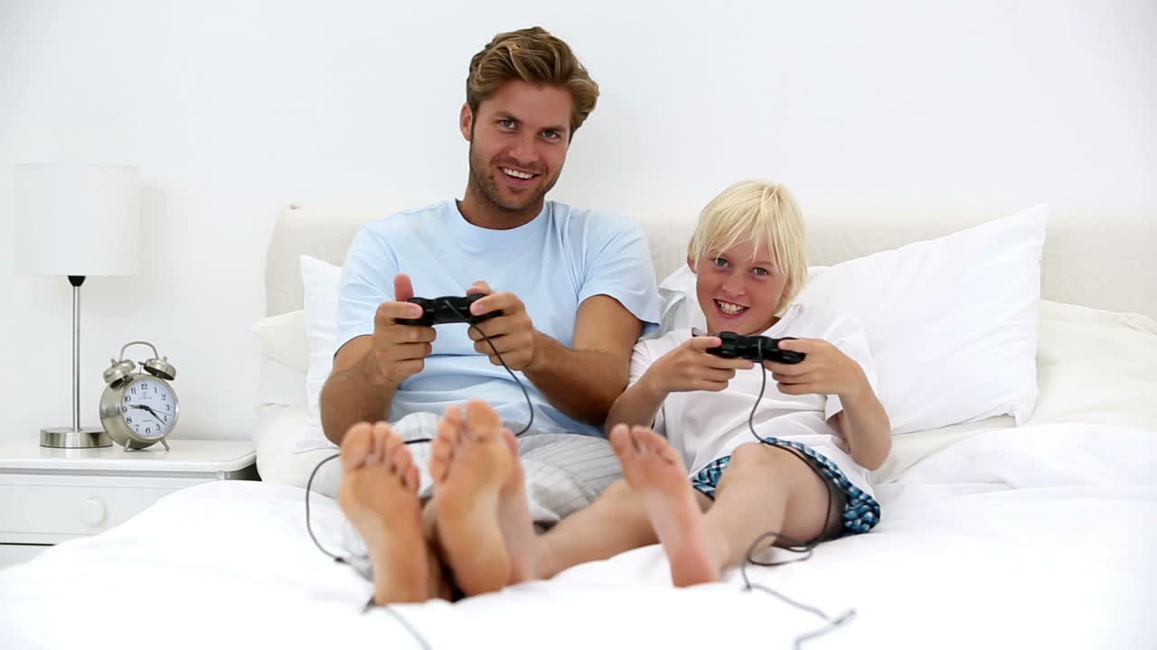 Father and son playing video games together