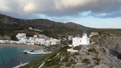 kapsali beach bay village with lighthouse and greece flag, kythira greek island