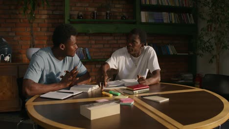 two black students studying together in a library