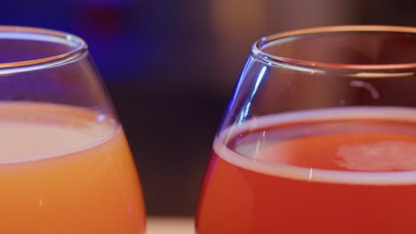 two glasses of colorful drinks