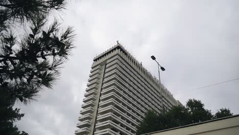 a multi-storey high-rise building against a cloudy sky. shooting of urban architecture by the sea