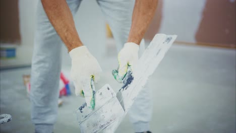 A Skilled Worker Applying Finishing Touches to a Wall with a Trowel and Plaster in a Renovation Project, Showcasing Precision and Care in Craftsmanship