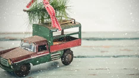 model car with a christmas tree on its roof combined with falling snow