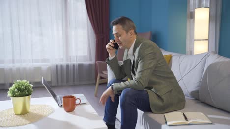 businessman in suit talking on the phone at home.