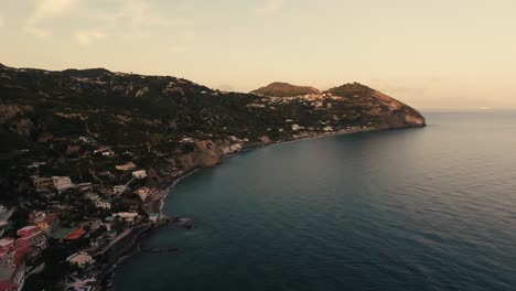 forward aerial along coastline of italian island ischia, golden hour