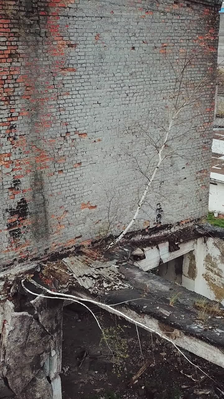 Abandoned factory. Aerial view of an old abandoned industrial building.. Vertical video