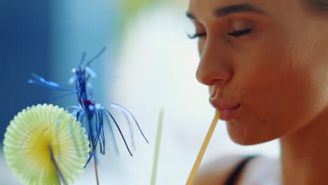 girl is drinking cocktail from a straw