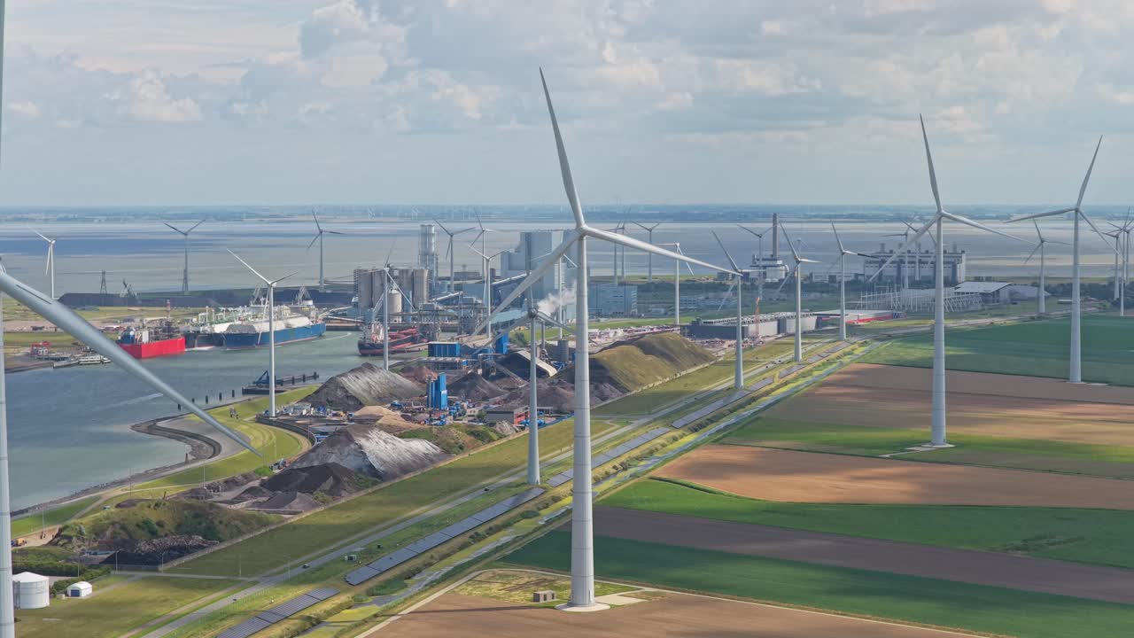 Aerial drone shot of Eemshaven port with wind turbines and industrial site