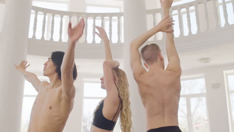 three professional contemporary dancers training dance moves in the studio