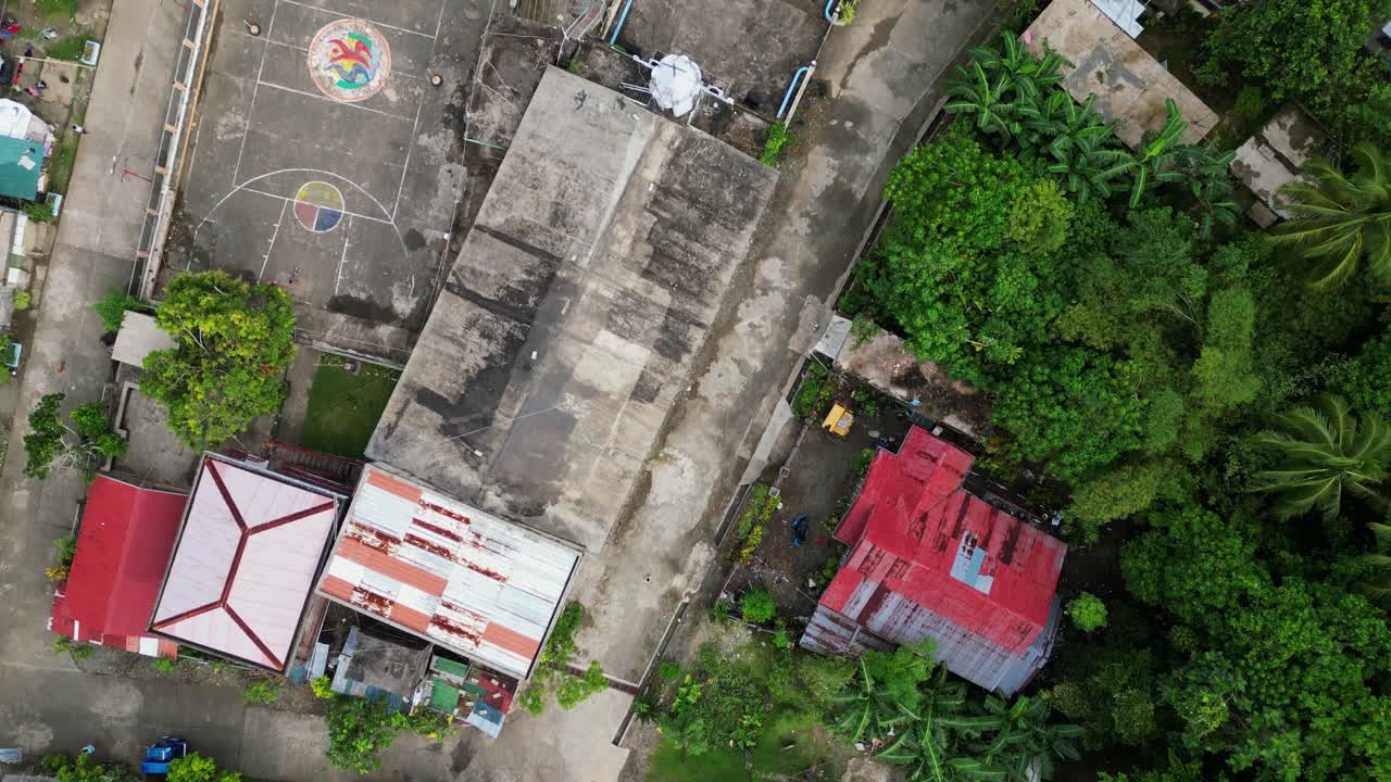 Panoramic view of Philippine island village plaza and church at Santo Domingo, Virac -aerial top-down