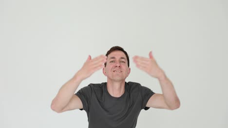 man gesturing expressively on white background
