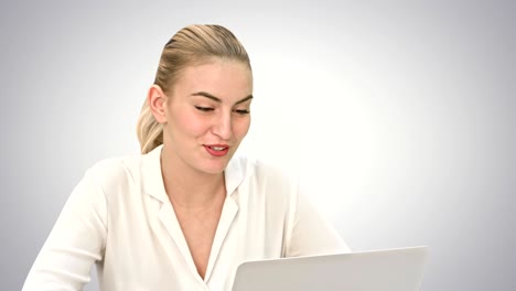 young businesswoman talking with partner online, using laptop computer on white background