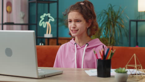 sad school girl using laptop loses online game lottery unsuccessful fail of passing education exam
