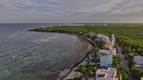 akumal mexico aerial v9 drone fly along coastline capturing seafront vacation homes, resort hotels, lush landscape of tropical plantations and ocean views - shot with mavic 3 pro cine - july 2023