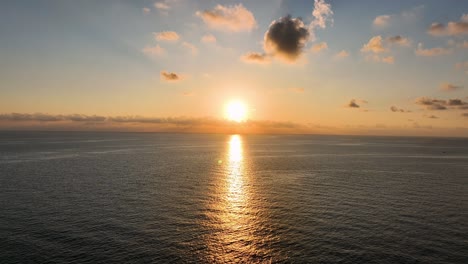 beautiful orange sunrise over calm sea shot by drone