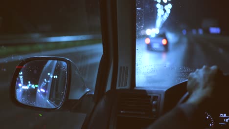 the man driving the car on the night highway