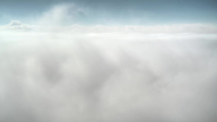 Aerial View of Dense Clouds Above the Horizon