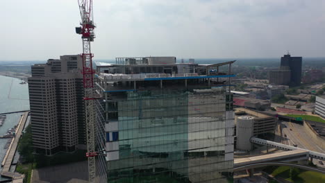 Aerial-view-of-a-high-rise-construction-site-at-a-river,-hazy-day-in-USA