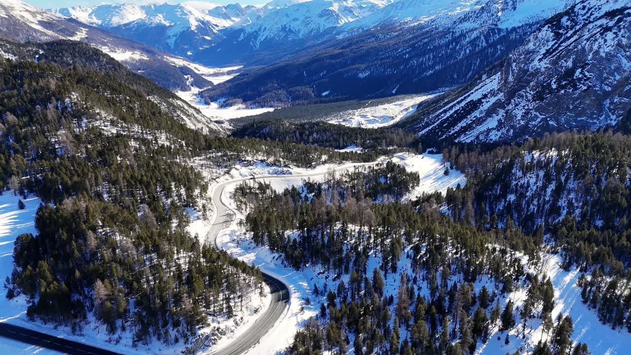 Amazing road in the Alps shot during the winter season (drone footage)