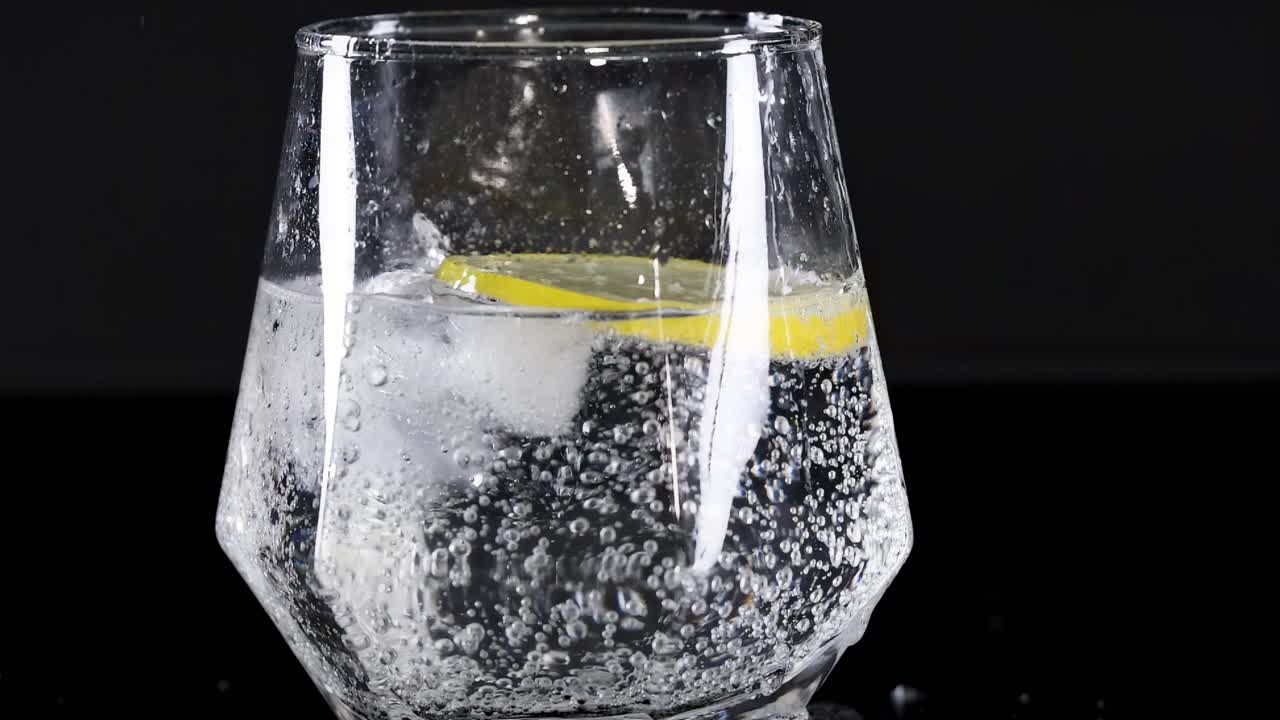 Bubbling soda with lemon slice in glass
