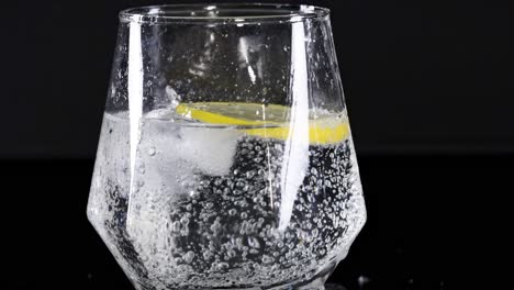 bubbling soda with lemon slice in glass
