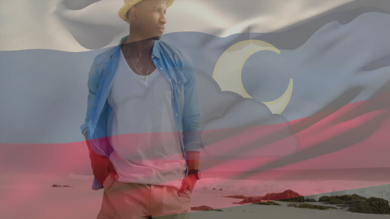 Standing on beach, man holding flag with moon animation overlay