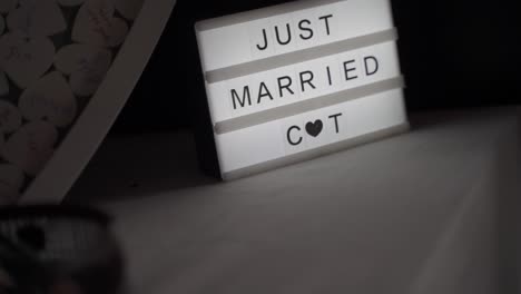 Just-Married-sign-with-the-words-cute-on-a-wedding-on-a-small-decorative-table