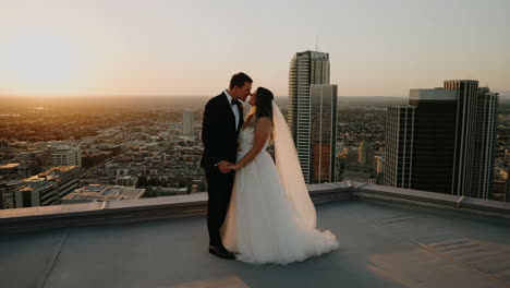 wedding couple on a city rooftop at sunset