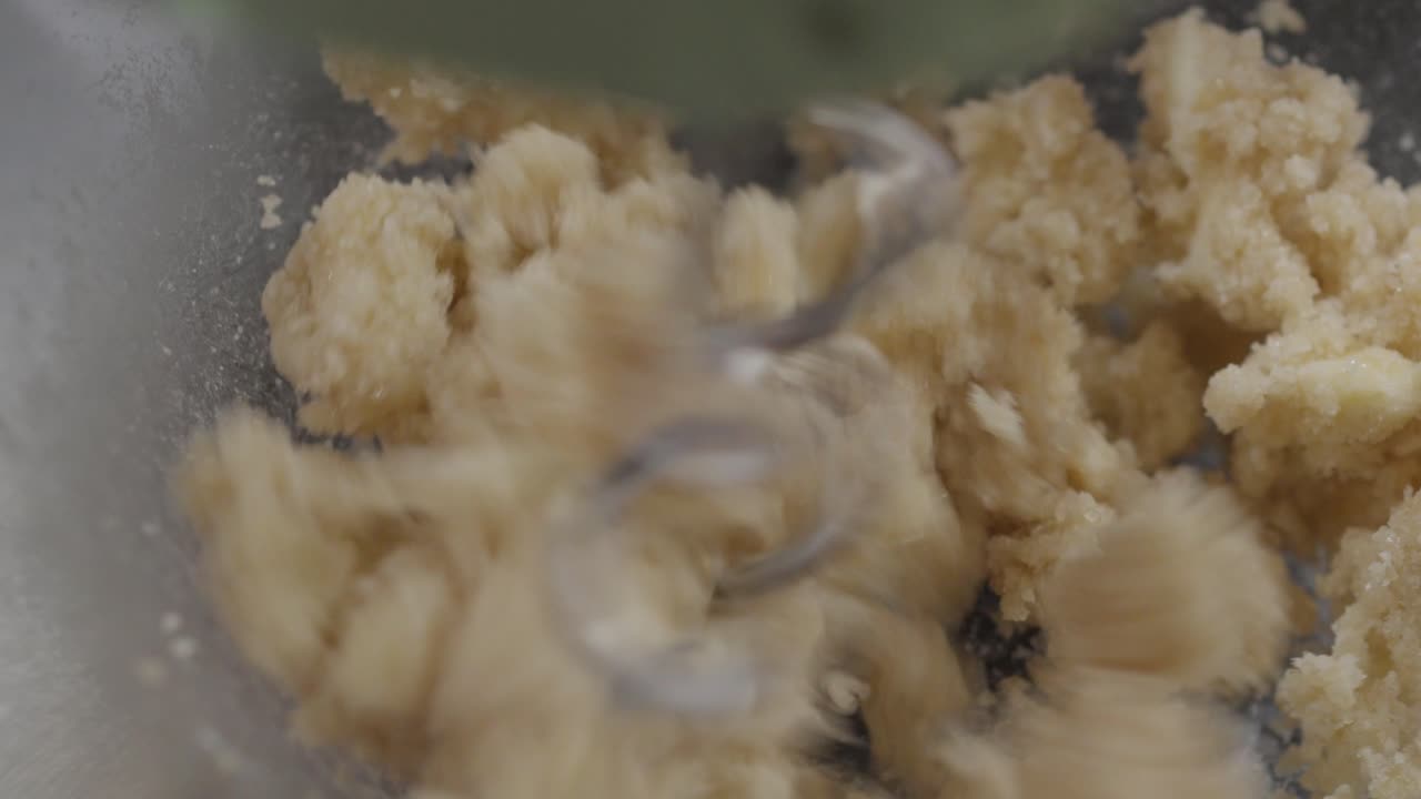 Creaming Butter and Sugar with Hand Mixer in Glass Bowl Close Up