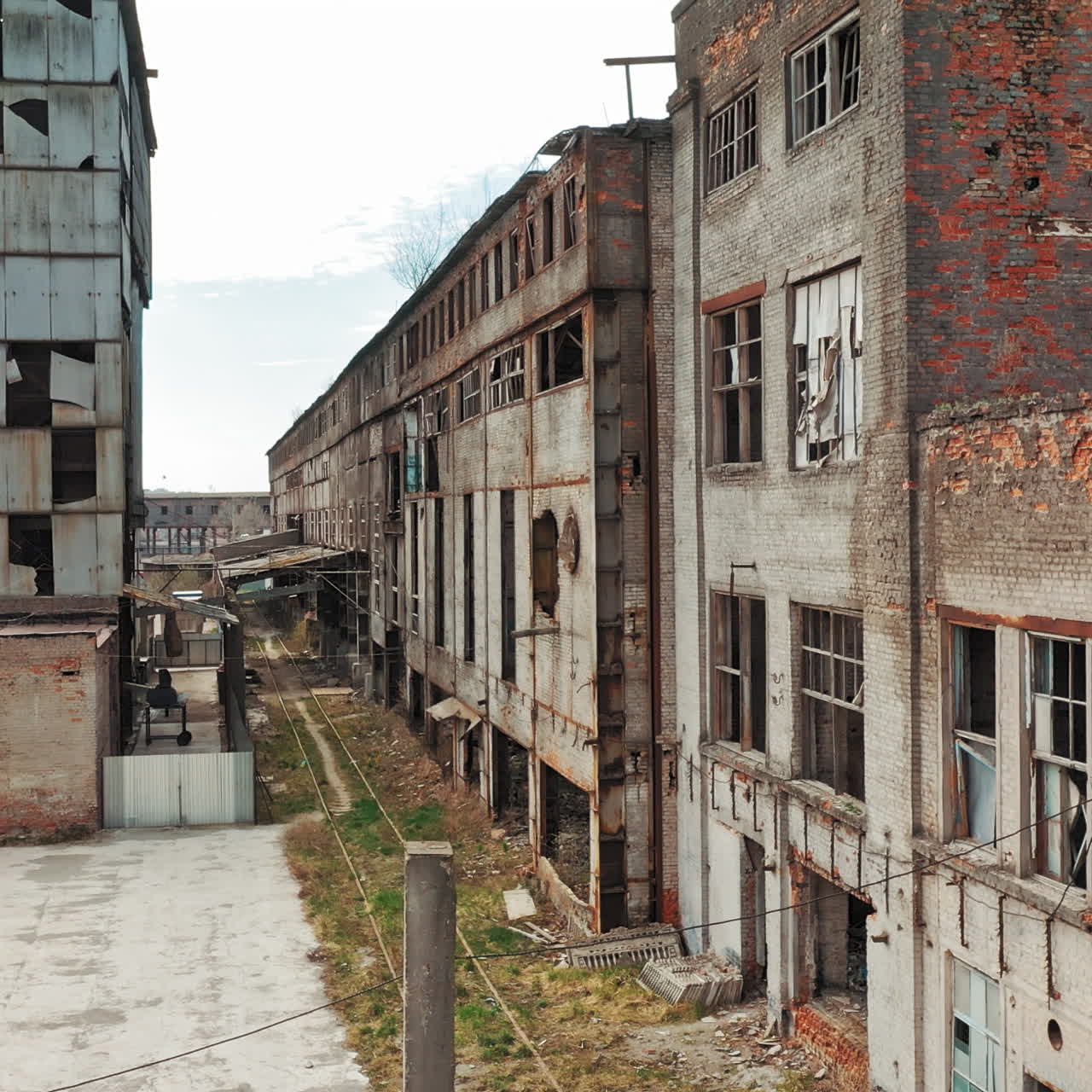 Aerial view of an old factory ruin and broken windows. Old industrial building for demolition.