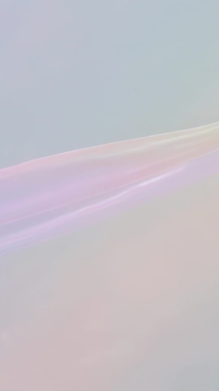 Vertical video: Starting loop iridescent ribbon moving across pastel backdrop, shifting hue for art