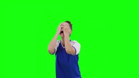 Video-of-caucasian-female-football-player-cheering-and-copy-space-on-green-screen