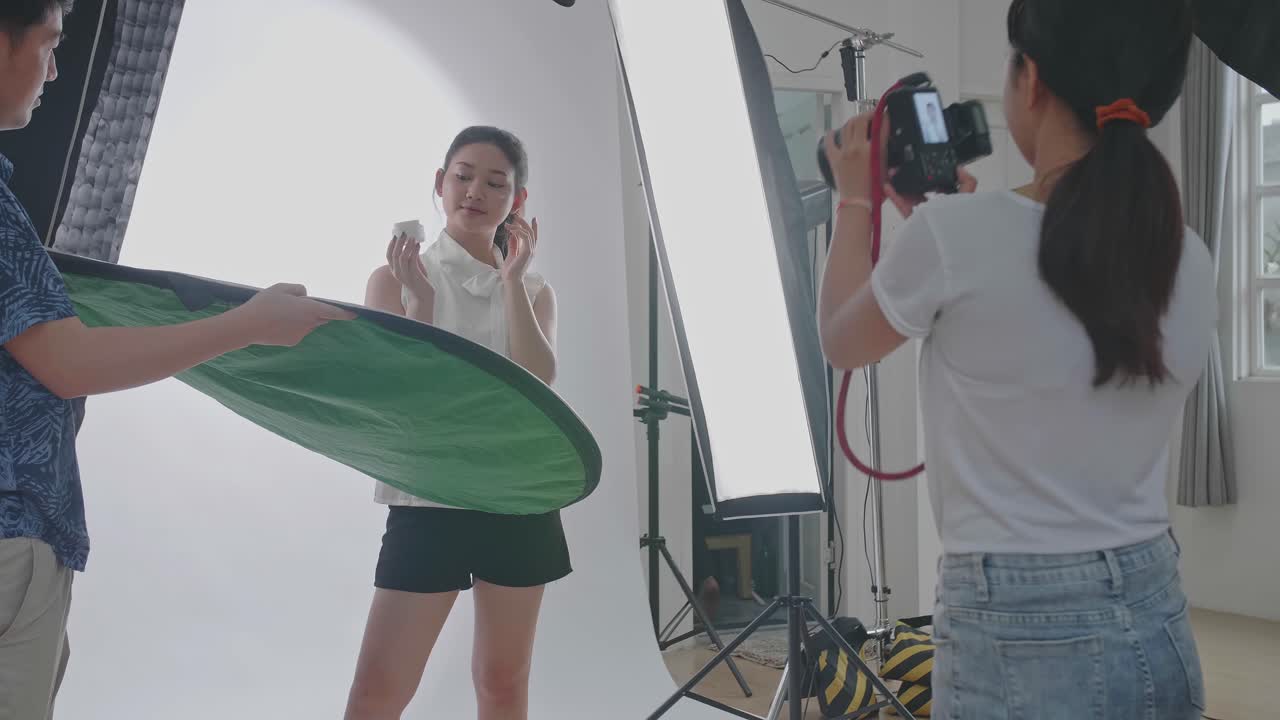 Behind The Scenes On Photo Shoot: Beautiful Asian Model Poses For A Photographer, She Takes Photos With Professional Camera