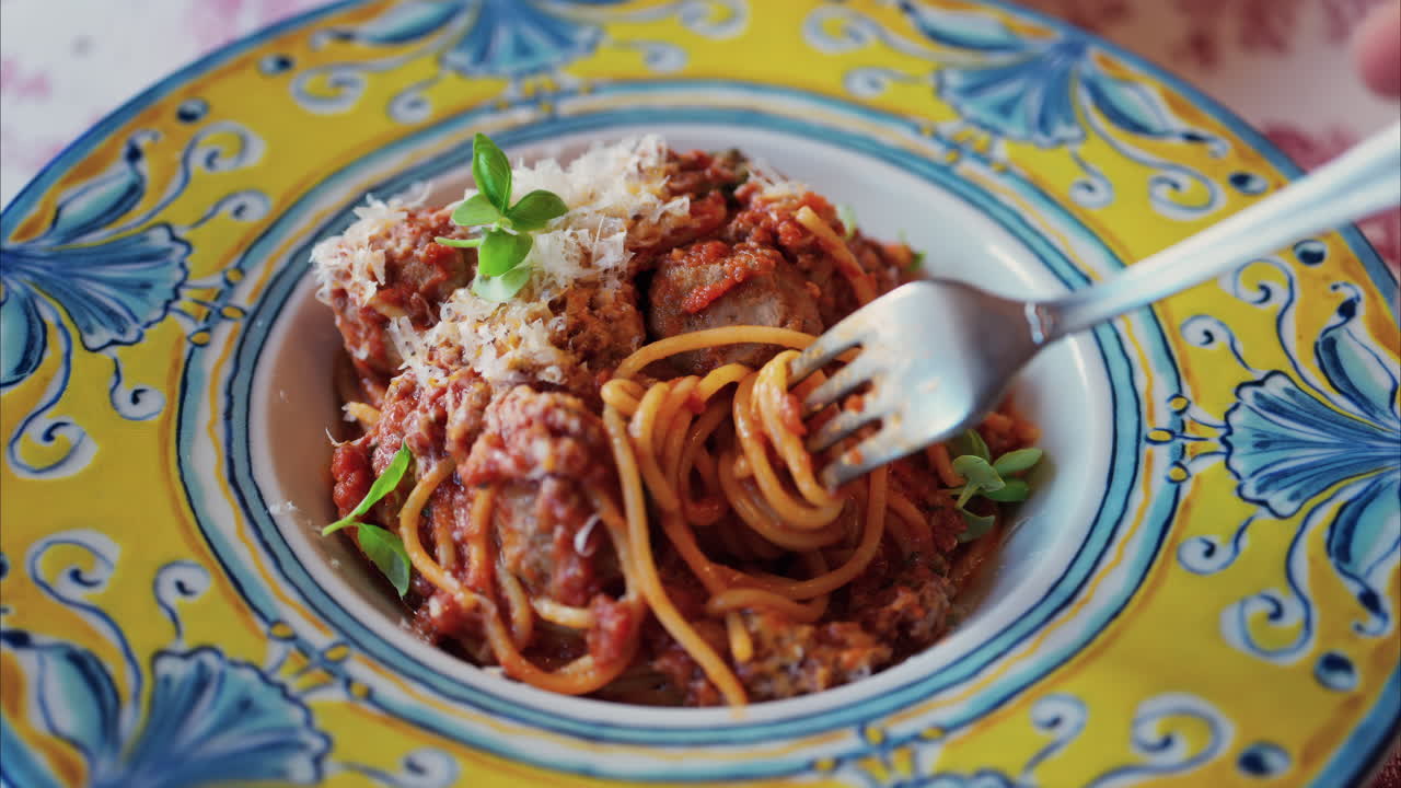 Close up of a woman eating pasta at an italian restaurant