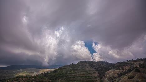 Cumulus-Clouds-Rolling-Over-Mountainscape.-Timelapse