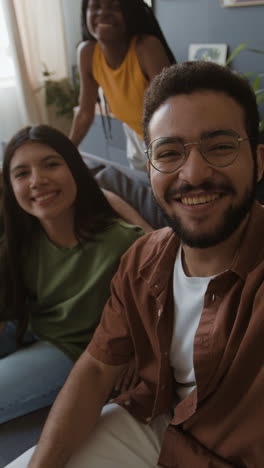 group of happy friends taking a selfie or video calling