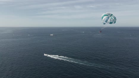 Living-life-fullest-parasailing-at-Cabo-San-Lucas-Mexico,-Baja-California-Sur,-aerial