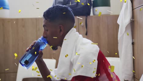 Animation-of-confetti-falling-over-football-player-drinking-water-in-changing-rooms