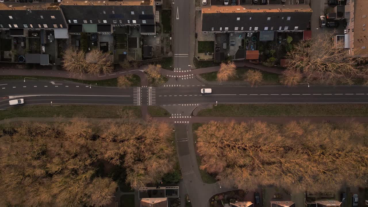 Aerial view of a residential area in the Netherlands, with a crossroad and surrounding houses and trees