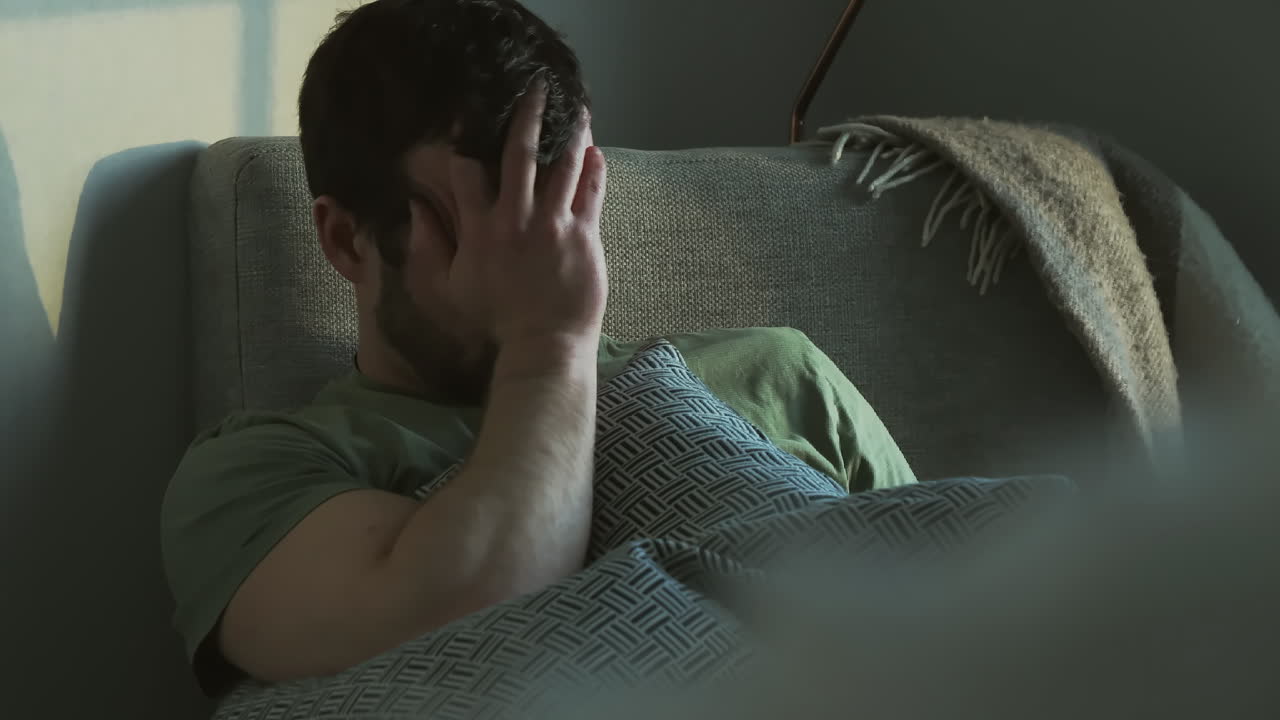 Depressed Man with Ptsd coping with traumatic war flashbacks alone at home, 4k