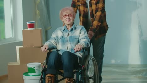 senior woman in wheelchair moving into new home with family