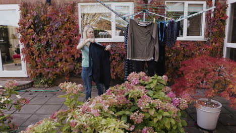 woman doing laundry in backyard