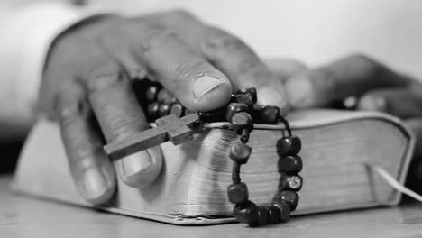 praying-to-God-with-hands-on-bible-on-table-with-people-stock-footage-stock-video