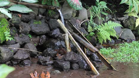 bamboo seesaw by utilizing a fountain or running water