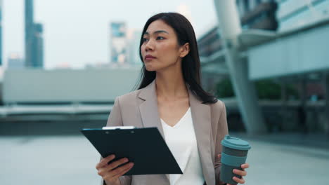 businesswoman reviewing documents outdoors