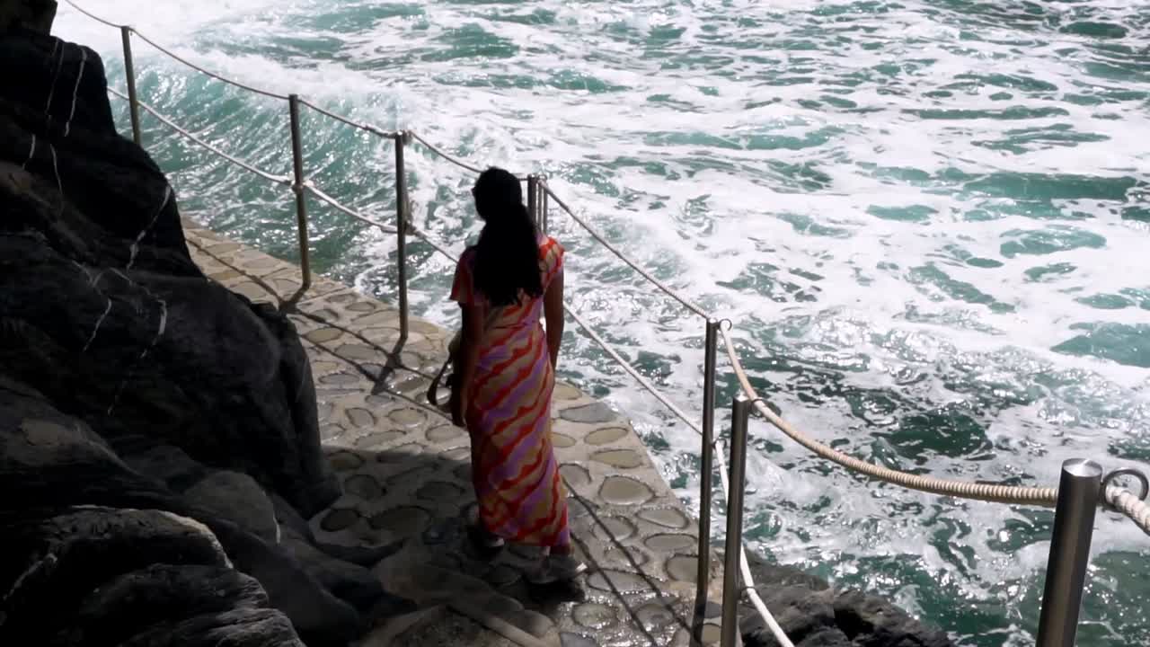 Woman On The Cliffside Cobblestone Walkway In Cinque Terre, Italy. Slow Motion Shot
